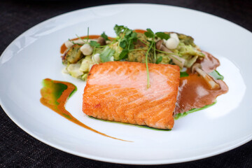 Grilled salmon and lemon - french cuisine dish with tomato and salmon
