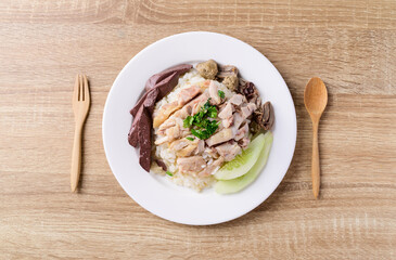 Thai food (Khao Man Kai), Hainanese chicken rice on plate with spoon and fork ready to eating, Top view