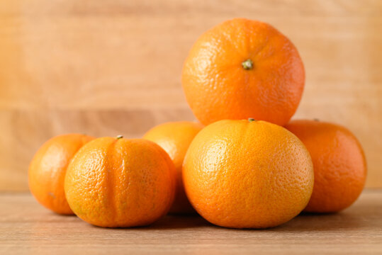 Fresh Honey Murcott orange fruit on wooden background
