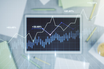 Multi exposure of abstract financial diagram and modern digital tablet on background, banking and accounting concept