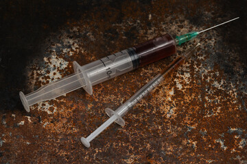 Syringe and drugs on dirty rusty background. Injection syringe. addiction
