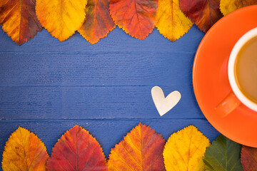Autumn & Time for Yourself Concept. Bright Leaves, One Silver Heart and Orange Cup of Coffee Latte...