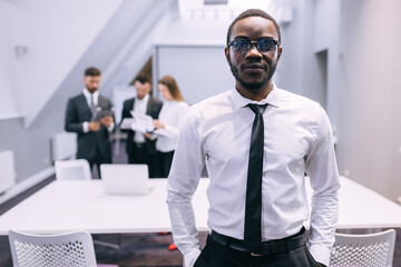 african american businessman stand in modern office, looking at