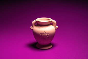 Oil jar for Jewish holiday Hanukkah on violet background.