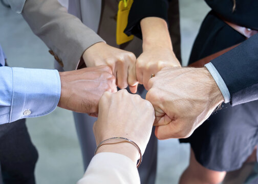 The top view of a group of businesspeople does circle shape hand and bump of the team in the office. Job successes and teamwork concept. Work of diversity of culture. Good environment in workplace.