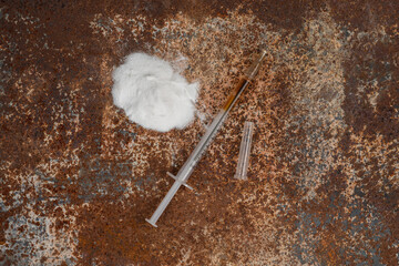 Syringe and drugs on dirty rusty background. Injection syringe. addiction