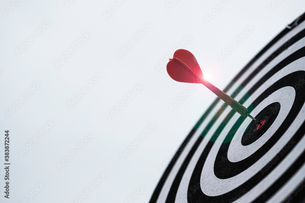 Poster dart arrow hit dartboard and goal with sunlight ,setup objectives and target for business investment