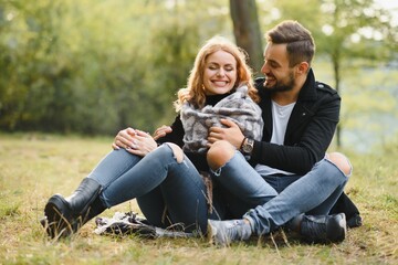 Fototapeta premium gentle and stylish couple are having a walk in the autumn park