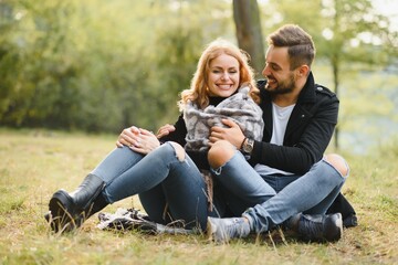 Romantic young couple in love relaxing outdoors in park