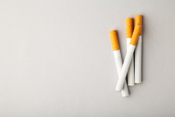 Cigarettes on grey background with copy space.