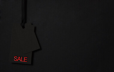 Black Friday sale. Black tag on the black background. Low-key