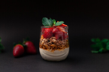 Yogurt with granola and strawberries on top