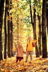 Boy and girl walking in autumn park