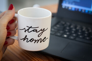 female hand holding mug at home 