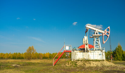 Oil rigs-rocking on the oil field near the road. Oil rig. copy space. 
