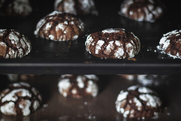 brown chocolate cookies with cracks and powdered sugar