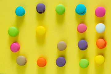 Creative layout made of macaroons on the yellow background. Flat lay. Food concept.