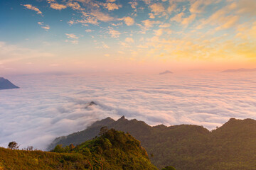 Beautiful landscape nature in morning on peak mountain with sunlight cloud fog and bright blue sky...