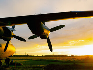 old Soviet military airplane, sunset time. Abandoned Historic Aircraft in Estonia AN-12. Close up...