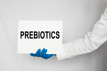 Doctor holding a card with text PREBIOTICS, medical concept