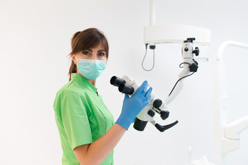 Dentist doctor using dental microscope
