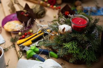 Нandmade christmas composition with red candles, pine cone and Christmas tree