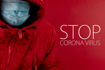 man in red jacket is using a protective mask against corona virus on red background, red color...