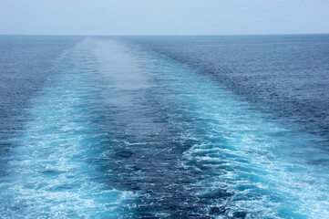 Waves and mark on the surface of the water from the ship sailed