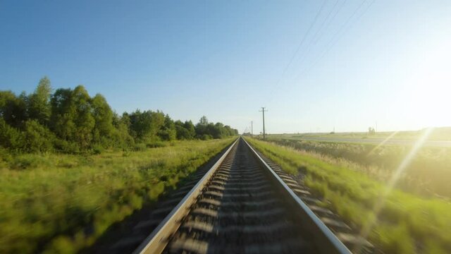 Fast flight close to train tracks in a clear sunny day
