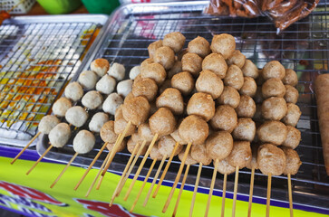 Deep-fried meatballs skewered on the stall. Thailand street food lifestyle.