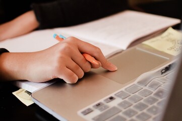 Closeup Hand Using Computer LapTop to Study and Learn School Work