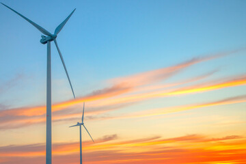 Windmills for electric power production at sunset