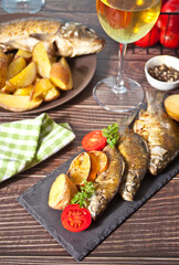 Grilled fish on plate with lemon and vegetables.