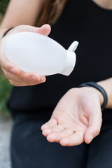 Woman using hand sanitiser 