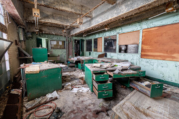 Inside an office in an abandoned shut down power plant—vandalism, decay, destruction, debris