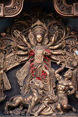 Idol of Goddess Devi Durga at a decorated puja pandal in Kolkata, West Bengal, India. Durga Puja is...