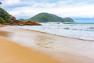 Deserted beach during rainy day with clouds in Trindade, Rio de Janeiro
