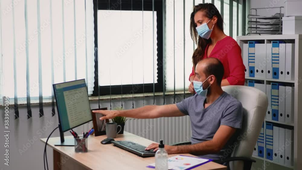 Poster business team working wearing protection mask in new normal office room. employees in modern corpora