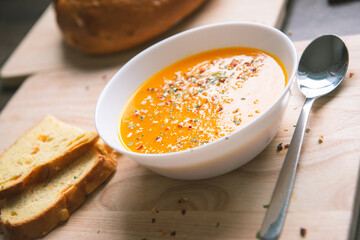 Closeup photo of seasonal autumn pumpkin soup and homemade pumpkin bread