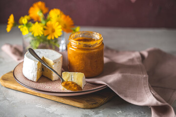 Chutney apricot with blue or bleu cheese on pink plate. Tasty food close up view