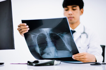 Radiology doctor examining at chest x ray film of patient at health care clinic