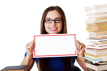 Beautiful young woman stuydent wih stack of books and holding co