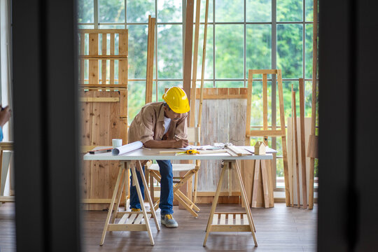 senior Asian man working on wood  work home improvement DIY in workshop recoding streaming online