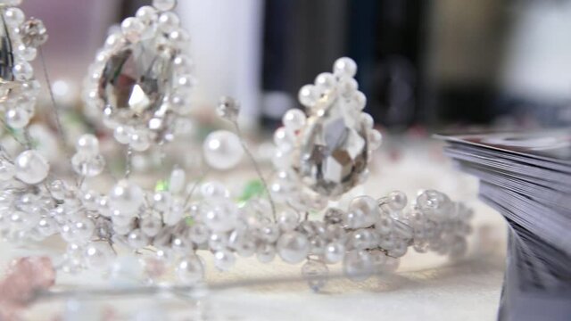 There is a crown on the table. Wedding accessory for the bride. Video