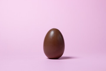 Chocolate egg on a pink background. Chocolate product