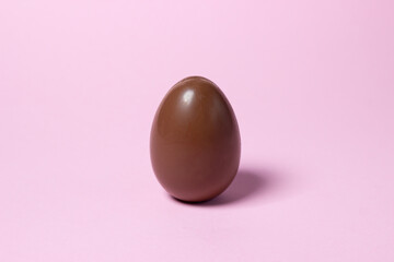 Chocolate egg on a pink background. Chocolate product