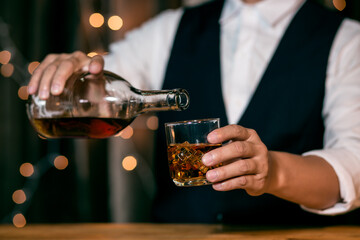 Whisky is poured into glass Beautiful bokeh