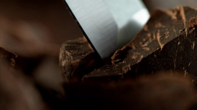 Super slow motion of cutting off dark chocolate pieces by chisel. Filmed with cinema high speed camera, 1000fps.