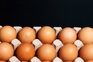 Egg tray with product at the bottom of the screen on a dark background. The upper part is free for advertising.