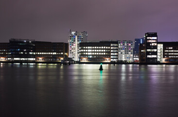 Modern architecture along the Kalvebod Brygge waterfront illuminated at night